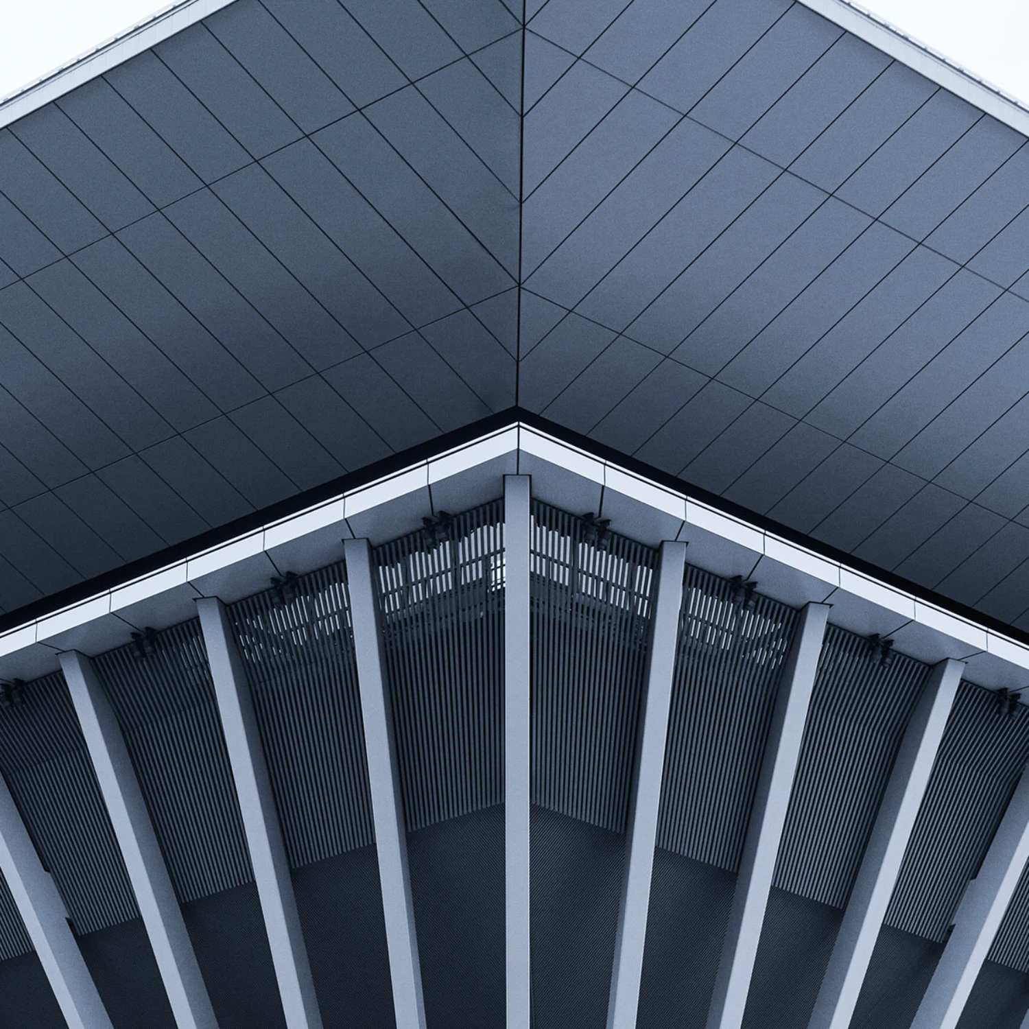 Minimalist architectural roof structure featuring sharp angles and vertical beams